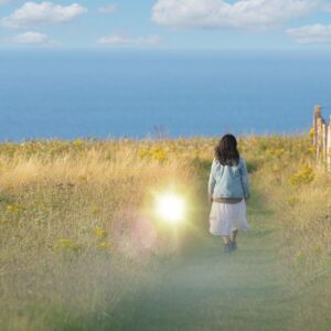 A woman walking along on a cliff